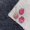 Close-up of pink iridescent resin nautilus shell bead with a silver eye pin for DIY jewelry - Rose Pink Conch