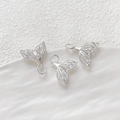 Macro detail of three silver hollow fishtail pendants with cubic zirconia for DIY jewelry - Hollow Fish Tail / Silver