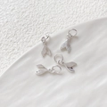 Close-up of four polished silver mermaid tail pendants for DIY jewelry making - Small Fishtail / Silver