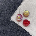 Macro shot of colorful glass snail beads with spiral texture and clear glass finish - Red Conch