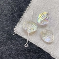 Macro shot of iridescent glass scallop beads with AB coating and silver metal pin - White Shell