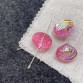 Macro shot of iridescent pink shell beads with wave patterns for DIY jewelry making - Rose Pink Shell