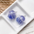 Macro detail of purple and white jellyfish resin charms with glitter for jewelry DIY - Blue