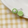 Detail of light green sunflower bead with white checkered center and back flower engraving - Sunflower (18#)