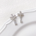 Close-up of asymmetric silver cross earrings with zircon pavé and teardrop charms - Zircon Cross / Silver