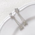 Close-up of silver five-petal flower stud earrings with dangling tassel chains and zircon - Flower Tassel / Silver