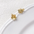 Macro detail of gold-plated five-petal flower charms with radial texture for DIY jewelry - Five-Petal Flower / Gold