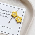 Close-up of bright yellow star-shaped alloy beads with four-hole button design for DIY crafts - Star Shape - Yellow
