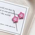 Close-up of pink star-shaped button beads with glossy enamel finish for DIY jewelry - Star Shape - Rose Pink