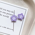 Macro shot of purple star button beads with four white center dots for jewelry making - Star Shape - Purple