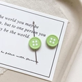 Close-up of light green button-shaped alloy charms for DIY jewelry and phone chains - Round-Green