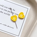 Macro shot of yellow heart button charms with needle pin for DIY jewelry making - Heart Shape - Yellow
