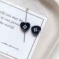 Macro shot of dark blue heart-shaped button beads for DIY jewelry and accessory crafting - Heart Shape - Black