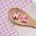 Close-up of pink butterfly resin beads with polka dots and patterns for DIY jewelry making - Rose Pink Double Layer Butterfly