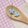 Macro view of blue butterfly resin beads with polka dots and center hole for DIY jewelry - Blue Dotted Butterfly