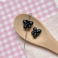 Macro detail of a black butterfly bead with pink dots for DIY jewelry making - Black Polka Dot Butterfly