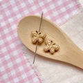 Detail of brown butterfly bead with pink dots in wooden spoon for DIY jewelry making - Khaki Polka Dot Butterfly
