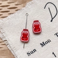 Détail de breloques bouteille de lait HAPPY rouges pour bijoux DIY et chaînes de téléphone - Bouteille de Lait Rouge