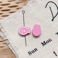 Close-up of pink fish enamel charms for DIY jewelry on textured linen and honeycomb paper - Rose Pink Dried Fish
