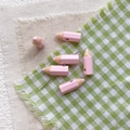 Close-up of pink pencil-shaped beads for DIY jewelry with smooth glossy finish - Pink