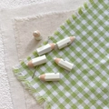 Detail of pencil-shaped beads with metal needles for DIY jewelry making and crafts - White