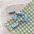 Macro detail of light blue enamel pencil charms for DIY jewelry making and handmade crafts - Blue