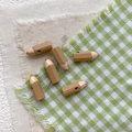Macro view of pencil-shaped resin beads in coffee and beige for DIY jewelry projects - Khaki