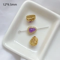Vista macro de cuenta de joyería en forma de calabaza de 12x9,5mm con gema púrpura y oro - Calabaza Morada Bañada en Oro