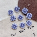 Macro shot of square Czech glass beads featuring purple Hawaiian flower Picasso patterns - 14#