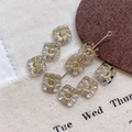 Macro detail of square Czech glass beads with golden sunburst pattern for DIY jewelry - 10#