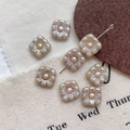 Macro shot of square Czech glass beads with embossed flower pattern for DIY jewelry - Size 8
