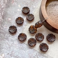 Detailed macro view of amber Czech glass flower beads with gold accents for DIY jewelry - Brown Amber