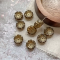 Macro detail of amber glass flower beads with gold edges for DIY jewelry making - Light Coffee With Gold Lines