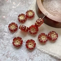 Macro view of red glass flower beads with gold accents for DIY jewelry making - Transparent Red With Gold Lines