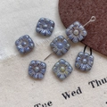 Detailed macro shot of vintage blue square Picasso glass flower beads for DIY jewelry - Style 1