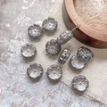 Macro view of metallic grey flower-shaped Czech glass beads with fine radial textures for DIY - Transparent Gray With Silver Lines