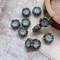 Macro detail of blue and reddish-brown flower beads for DIY jewelry making - Dark Red With Blue Lines