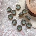 Close-up of Czech glass plum blossom beads with vintage bronze texture and petal details - Dark Coffee With Green Lines