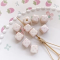 Macro shot of white ceramic cube beads with pink star patterns for DIY jewelry making - 3# Light Yellow Star Style