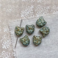 Macro view of vintage Czech glass cat head beads for DIY jewelry making - Vintage Blue