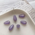 Macro detail of violet glass teardrop beads with gold stroke for DIY jewelry making - 9# Transparent Purple Gold Edging