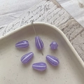 Macro shot of matte lavender Czech glass teardrop beads with white stripes in a ceramic dish - 7# Transparent Purple Silver Edging
