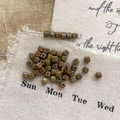Macro shot of vintage Picasso finish square Czech glass beads for DIY jewelry making - Size 9
