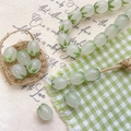 Detailed view of lily of the valley glass beads for handmade jewelry DIY crafts - Translucent Mint Green