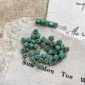 Macro detail of Morandi green Czech glass cube beads for DIY handmade jewelry crafting - Size 6
