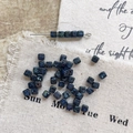 Macro detail of blue and green Picasso style square glass beads for DIY jewelry making - Size 7