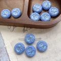 Macro detail of lavender Czech glass daisy charms with floral relief for DIY jewelry making - Pale Purple (7#)