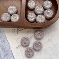 Macro view of vintage lavender glass flower beads with golden embossed daisy patterns - Purple With Gold (1#)