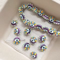Detailed view of colorful evil eye striped resin beads for DIY jewelry making - Purple
