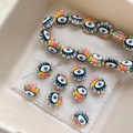 Detailed view of colorful evil eye handmade ceramic beads for DIY jewelry making sets - Blue
